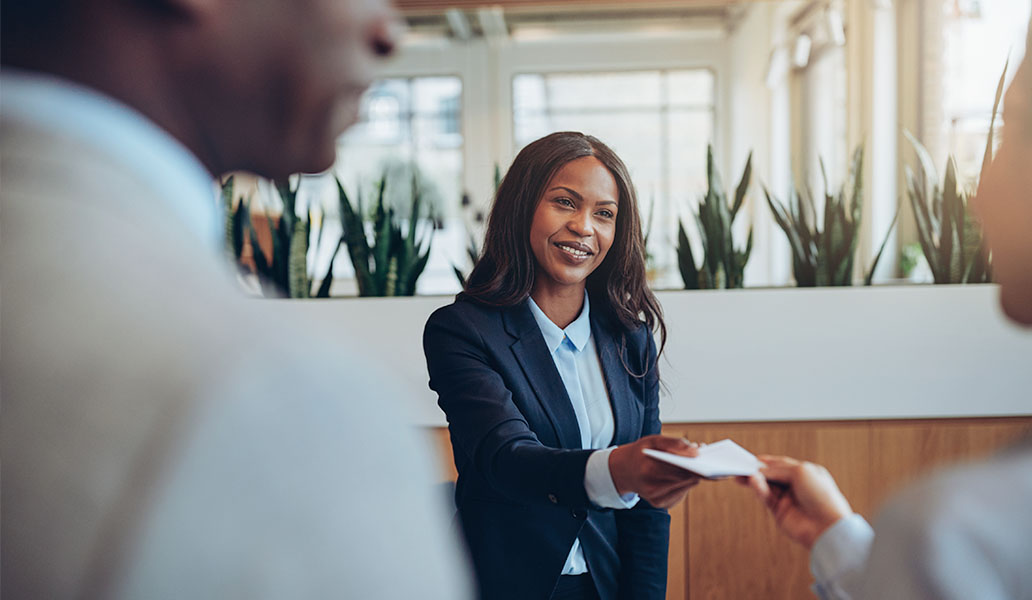 Woman working at front of desk at hotel